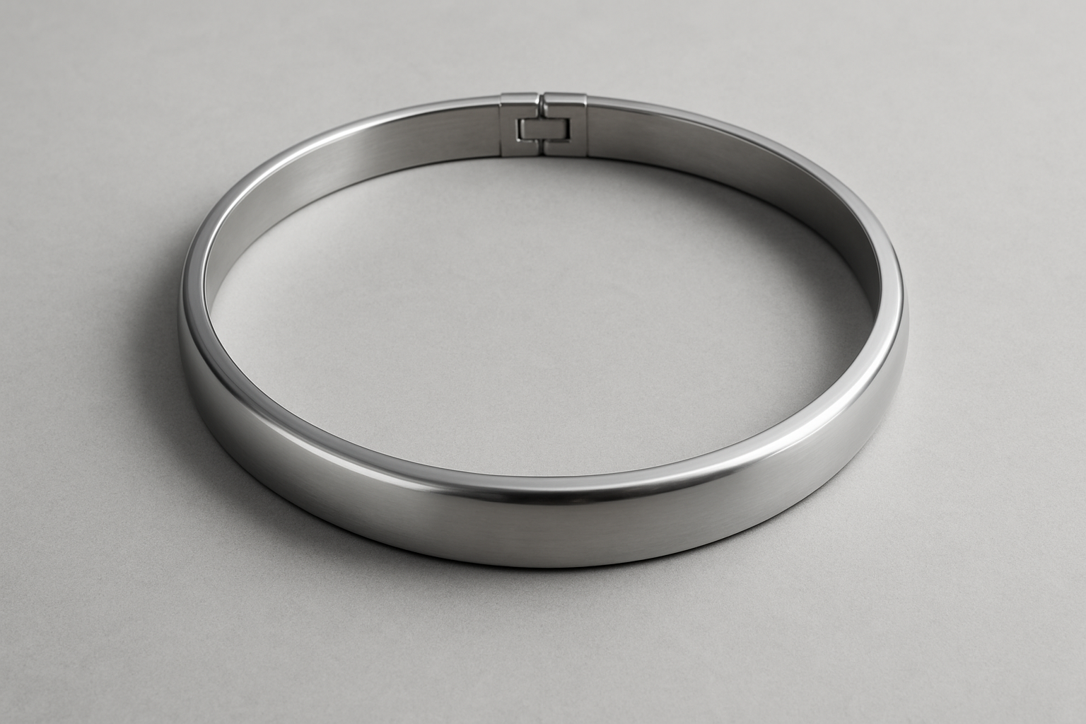 Precision-machined metal cylinder neck ring with a seamless hinged joint, displayed on a neutral background