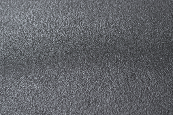 Close-up view of a phosphated steel surface, showing fine microcrystalline texture in shades of gray.