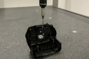 Renishaw CMM probe measuring a plastic part, used for precise quality control in manufacturing.