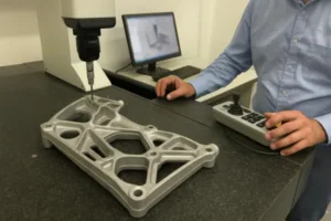 Quality control inspection of an aluminum casting part using a coordinate measuring machine (CMM).