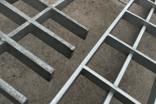 Close-up of galvanized steel grating, showing the grid pattern and smooth surface finish.