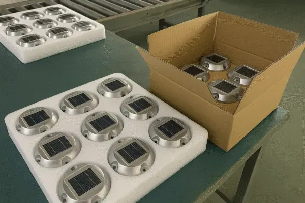 Solar-powered road markers packed and ready for shipment in a warehouse.