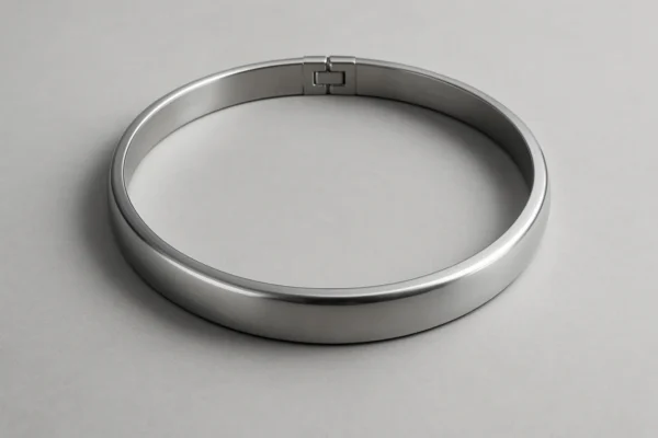 Precision-machined metal cylinder neck ring with a seamless hinged joint, displayed on a neutral background