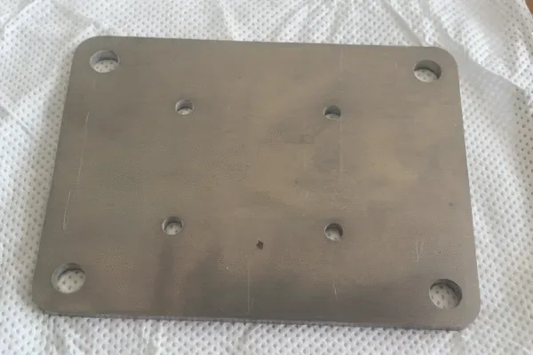 Stamped metal mounting plate with holes and formed features