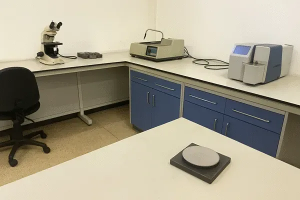 Quality control laboratory with microscope, material testing instruments, and sample scale for metal parts inspection