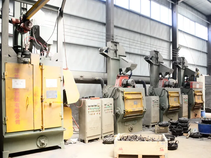 Industrial casting process showing molten metal being poured from a ladle into a sand mold, with sparks illuminating the foundry environment.